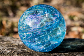 sky blue glass orb with cremation ash