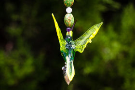 Colorful glass hummingbird with a sterling silver heart keepsake pendant and crystal butterfly, suspended on a beaded strand.