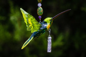 Vibrant multicolor glass hummingbird pendant with beaded necklace and a sterling silver cylinder keepsake urn.