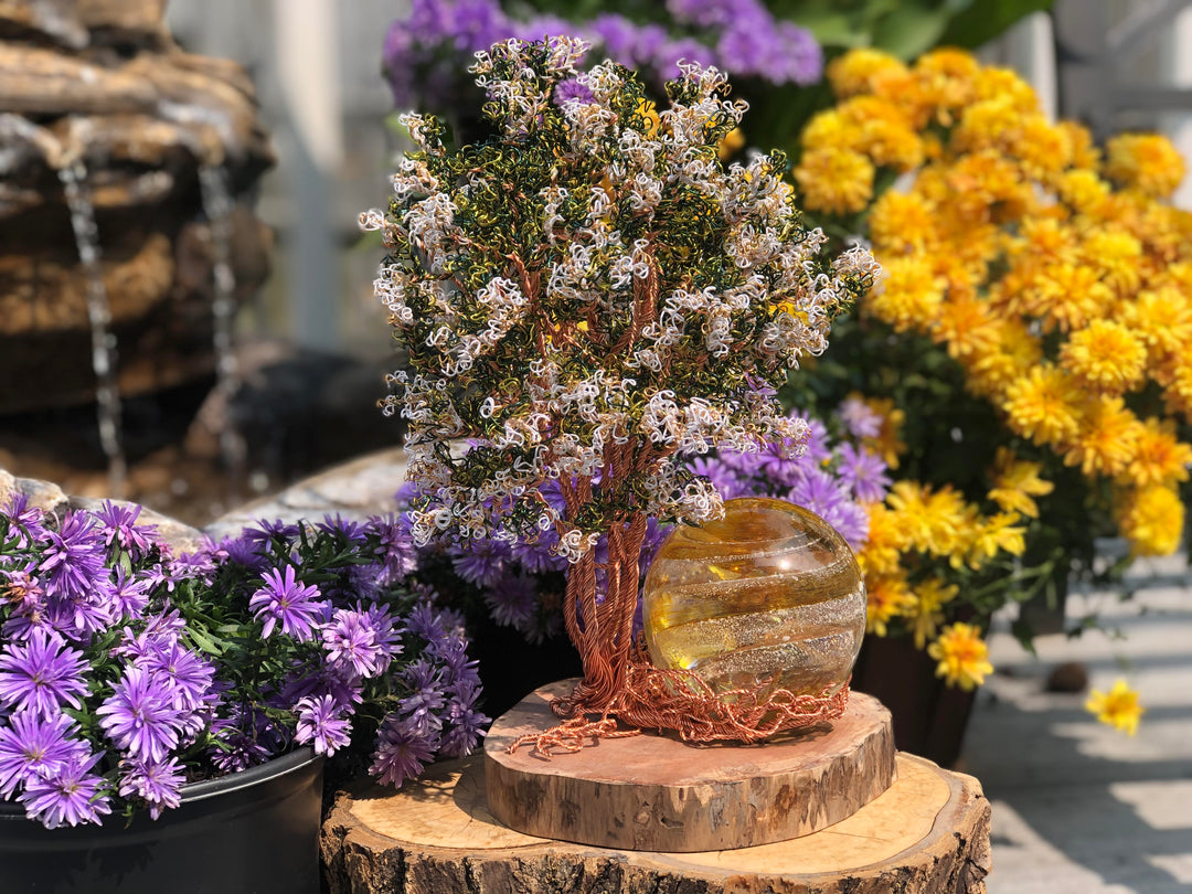 Handcrafted Crepe Myrtle Tree of Life memorial with a sparkle orb beside it on a wooden stand