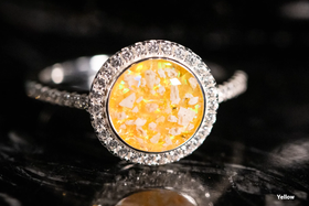 Photo depicts our Bedazzled Circle Opal Cremation Ring, in the color yellow, sitting on a glass surface. Sterling Silver Ring, Sterling Silver Ring for Ash, Ring for Cremation Ash, Sterling Silver Remembrance Jewelry, Sterling Silver and Cubic Zirconia Ring